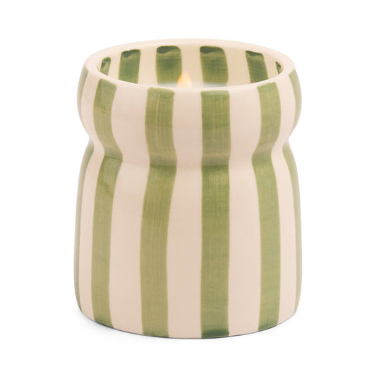 The Cabana Sage Candle - Bora Bora sits in a cream ceramic holder with vertical green stripes and a wavy shape, infusing your space with BORA BORA notes.